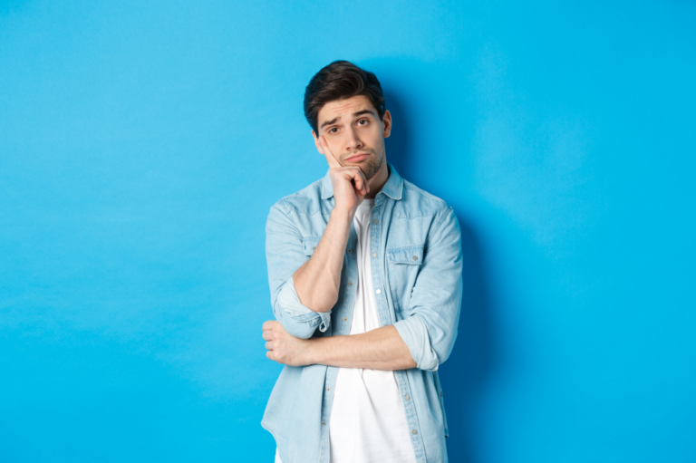 Honeyview unamused bored man looking without interest camera standing against bllue background 1