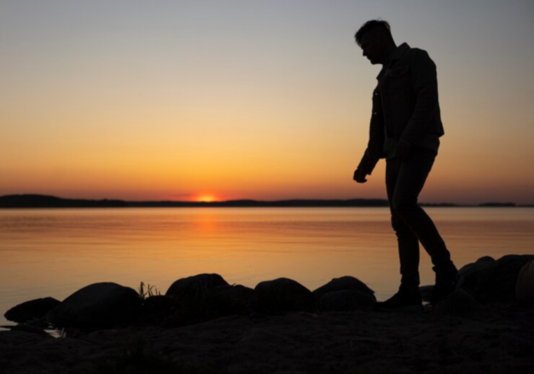 sad contemplative person near lake 23 2150420662